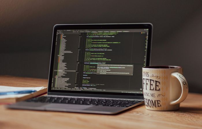 Web developer coding on a laptop screen